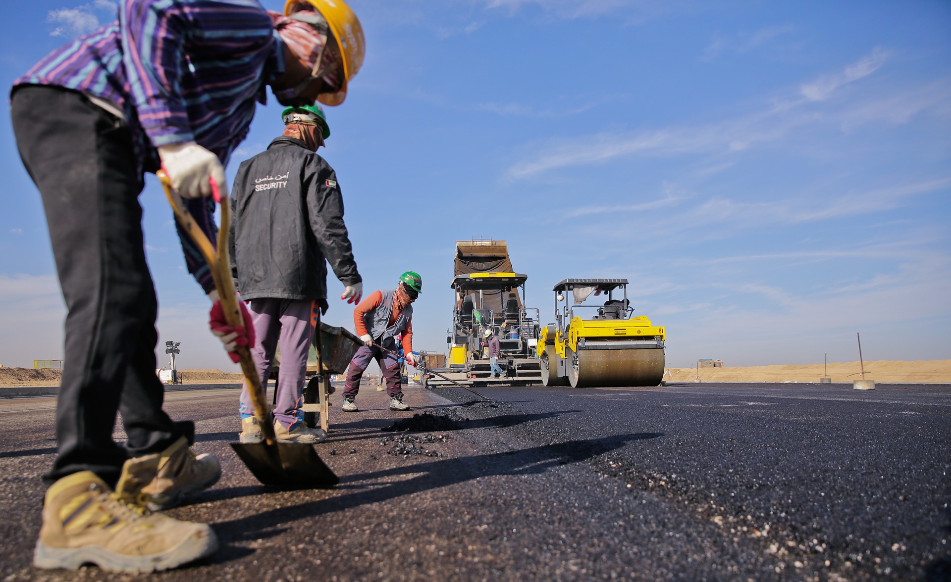 Road construction crew laying asphalt